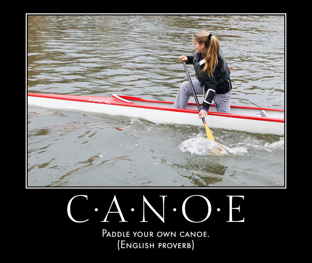 woman paddles canoe